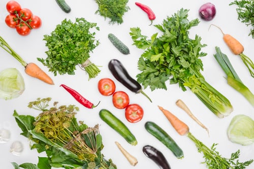 Preview: full frame of fresh autumn vegetables arranged isolated on white