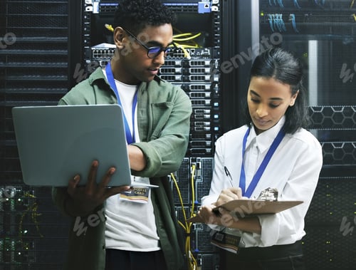 Preview: Make a note of this. Shot of two technicians working together in a server room.