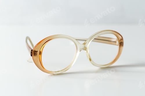 Preview: Clear and brown glasses placed on a white surface in a well-lit room