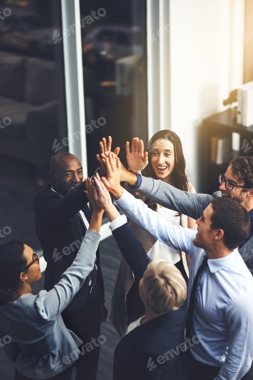 Preview: Were going to succeed no matter what. Shot of a group of businesspeople high fiving in an office.