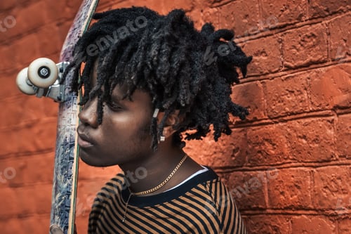 Preview: Portrait of young handsome stylish black man with natural hair dreadlocks. Afroamerican guy. Wall pa