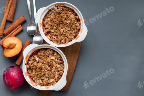 Preview: Plum crumble pie or plum crisp with oats and spices, in baking d