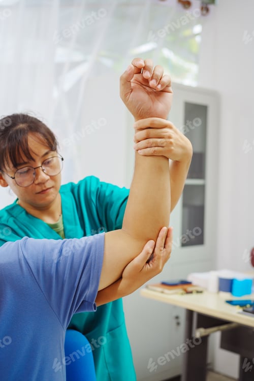 Preview: A female doctor performs physical therapy male patient in hospital,using techniques like pulling