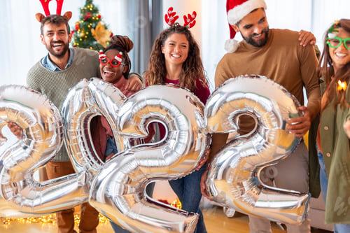 Preview: People holding giant balloons shaped as numbers 2022 while celebrating New Year