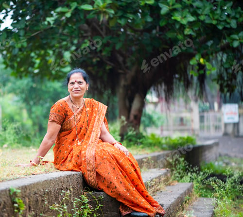 Preview: Happy Indian woman in traditional clothes at outdoor.