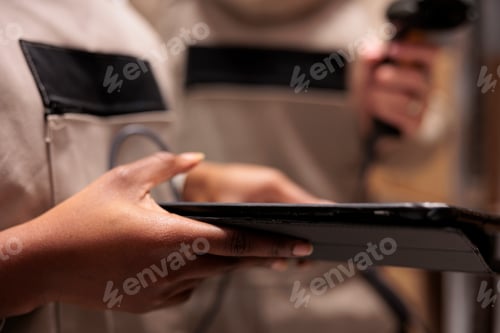 Preview: Storehouse employees hands using digital tablet in stockroom,