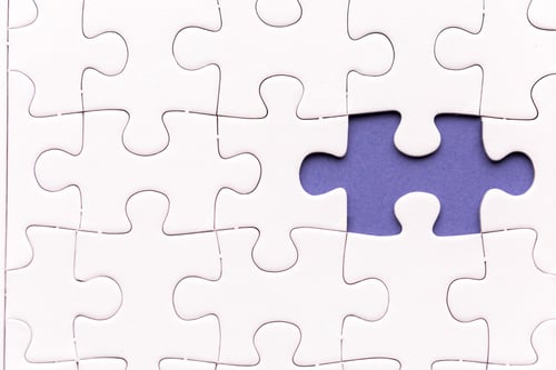 Preview: Unfinished white jigsaw puzzle pieces. One missing jigsaw piece on purple background