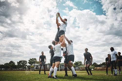 Preview: Shot of two rugby teams competing over a ball during a line out of a rugby match outside on a filed