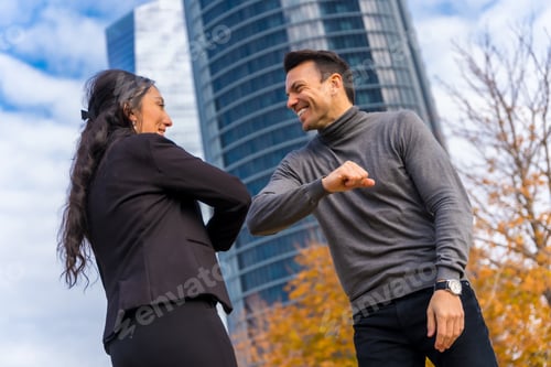 Preview: Multi-ethnic businessman and businesswoman, smiling and greeting, new greeting after coronavirus