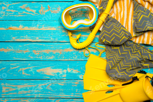 Preview: Bright snorkeling gear laid out on a vibrant wooden surface ready for an ocean adventure