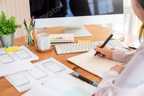 Preview: Designer woman drawing a website outline and website ux app development on mobile phone.