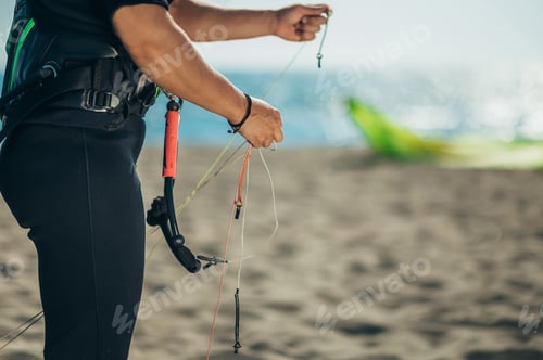 Preview: Woman using flying lines and a control bar for kitesurfing