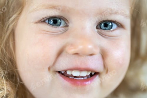Preview: Portrait of a little girl with big blue eyes.