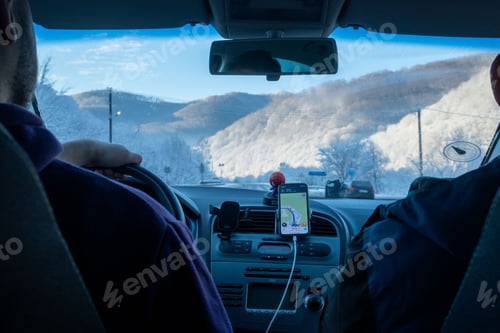 Preview: Zakoraptya, Ukraine - January 29, 2022: steering wheel by snowed road in mountains