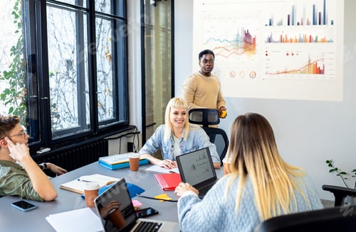 Preview: Diverse group of young business people working on new project together in office.