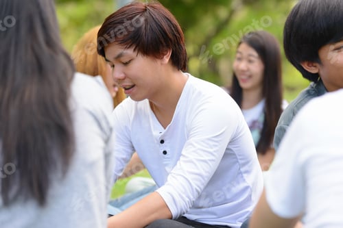 Preview: Happy young group of friends having fun together at the park