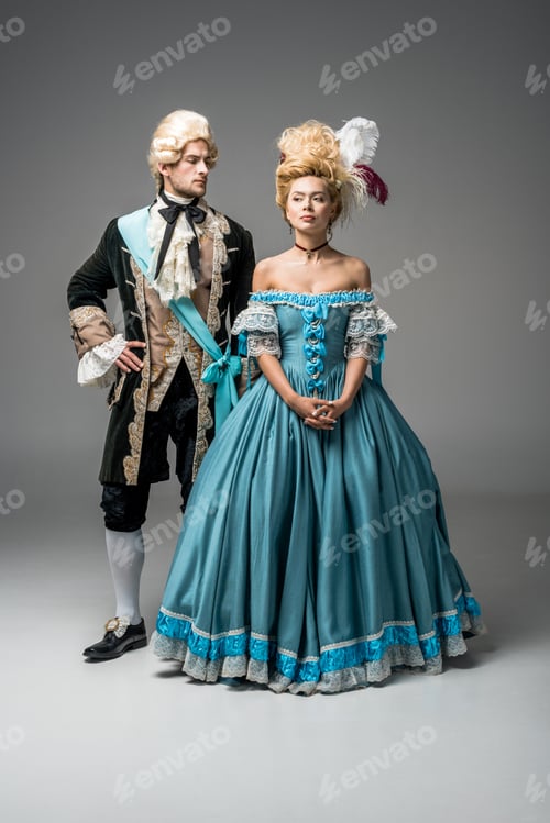 Preview: attractive victorian woman in blue dress near handsome man with hand on hip on grey