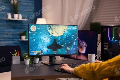 Preview: Closeup of gamer player woman playing space shooter videogames
