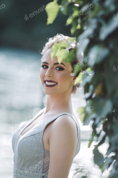 Preview: Attractive young Caucasian female with beautiful makeup wearing an elegant evening gown