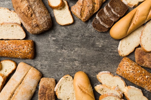 Preview: Homemade natural breads. Different kinds of fresh bread as background, top view with copy space