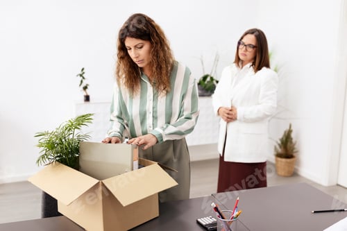 Preview: Caucasian businesswomen organizing office supplies in a modern workspace