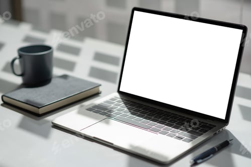 Preview: Office desk with laptop blank white screen with notebook coffee mugs. Mock up.