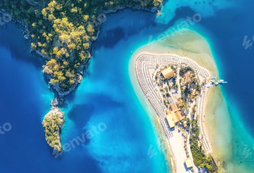 Preview: Aerial view of sandy beach green trees, mountain at sunset