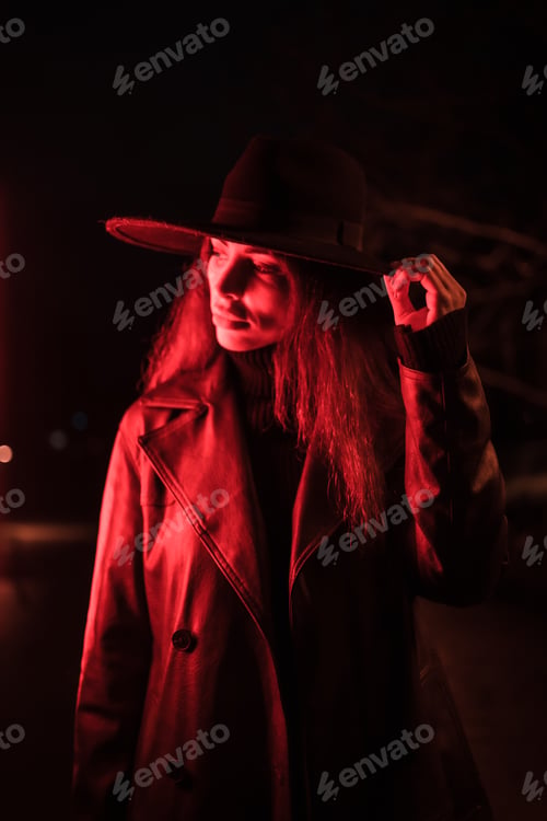 Preview: Girl in a hat in a portrait at night in a raincoat on a parcel