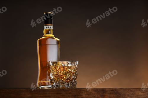 Preview: Whiskey in glass and bottle on wooden table against brown background, space for text
