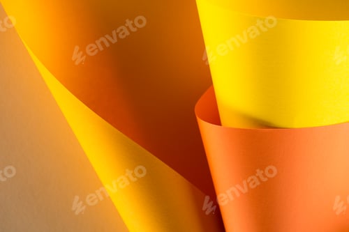 Preview: close-up shot of rolled orange and yellow papers for background