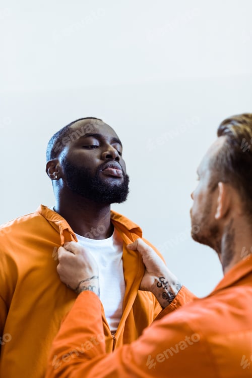 Preview: prisoner threatening african american cellmate isolated on white