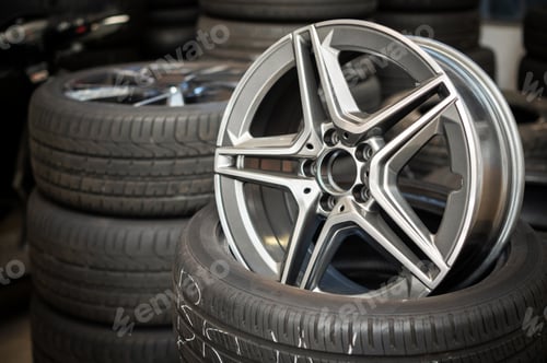 Preview: Car wheel rim placed on tire in workshop