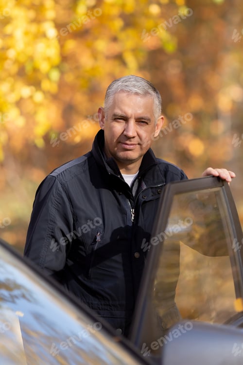 Preview: portrait of a young man near cars