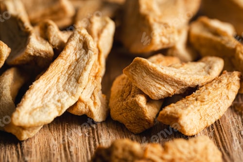 Preview: Homemade dried organic apple sliced on wood background.