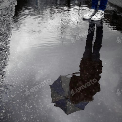 Preview: Puddle and silhouette reflection with umbrella