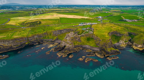 Preview: Aerial view of a scenic, green island in Ireland, featuring the Dunluce Castle