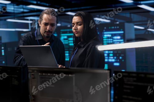 Preview: Coworkers in data center doing routine disk checks using laptop and tablet