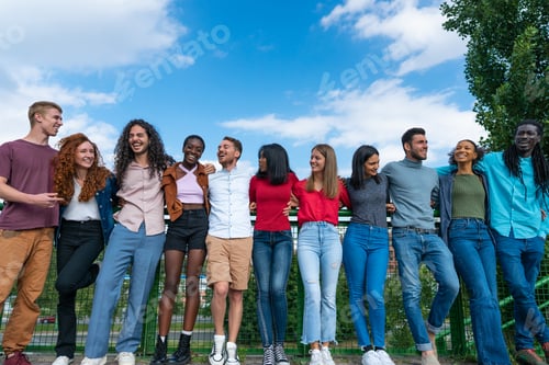 Preview: Group of international friends bonding outdoors - Multicultural people laughing outside