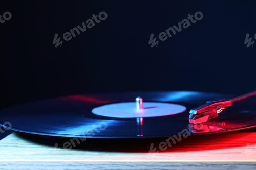 Preview: Turntable with vinyl record on wooden table, closeup