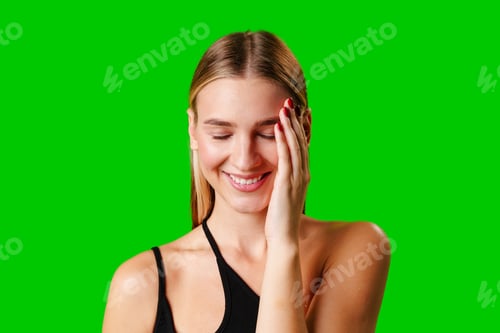 Preview: Smiling Young Woman in Casual Outfit Posing Against Green Background