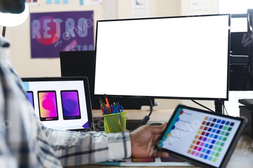 Preview: Midsection of indian male designer using tablet and computer with copy space at desk in office