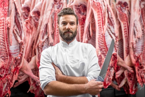 Preview: Portrait of a butcher at the meat manufacturing