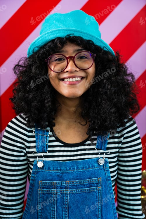 Preview: Beautiful young hispanic woman with curly hair portrait at home