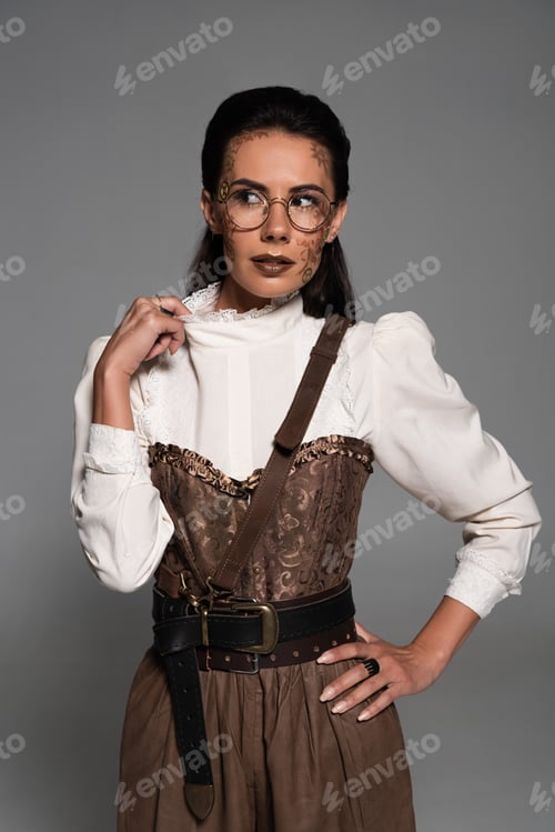 Preview: front view of pensive steampunk woman with makeup looking away isolated on grey