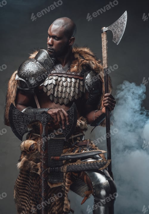 Preview: Tribal authentic soldier with axes in foggy background looks away