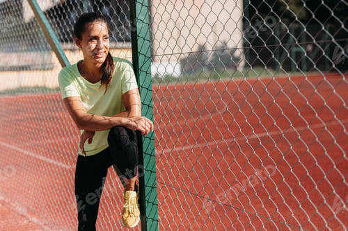 Preview: Happy lady in sport clothing smiling and looking aside