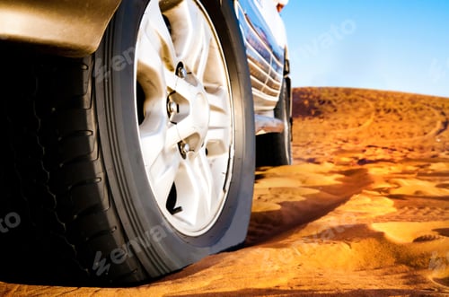 Preview: wheel of a car on the sand