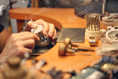 Preview: Male jeweler working with an engraving tool