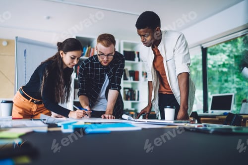 Preview: Group of smart casual developers working with project sketches for architect order