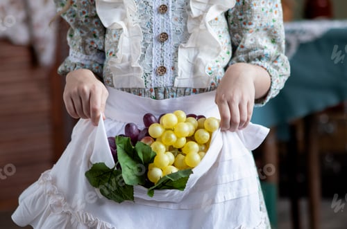 Preview: girl with long blond hair with a grape harvest in her handsgirl with long blond hair with a grape ha